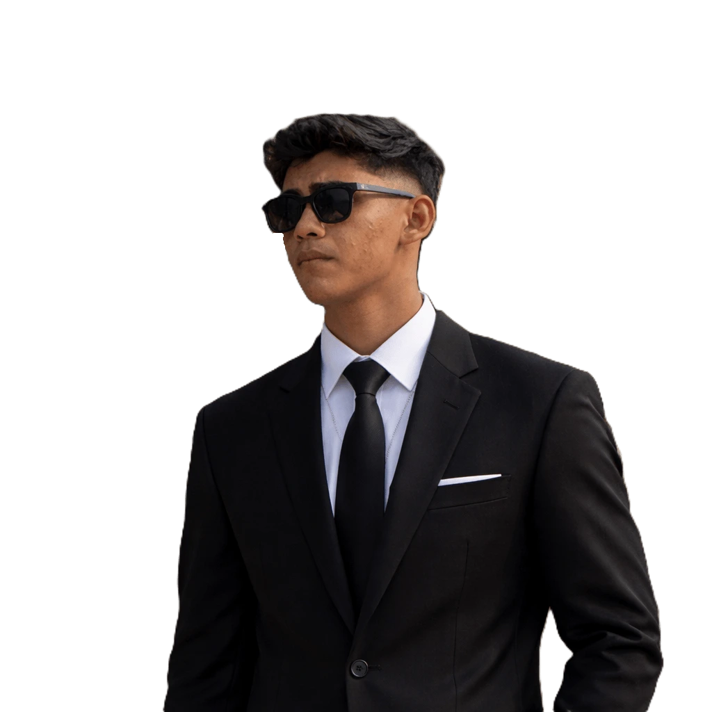 Digital marketing freelancer in Calicut Sanish Muhammed wearing a black suit and sunglasses, smiling in a professional profile photo for a personal website.